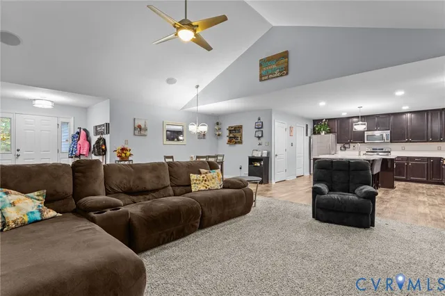 a living room with furniture and a chandelier