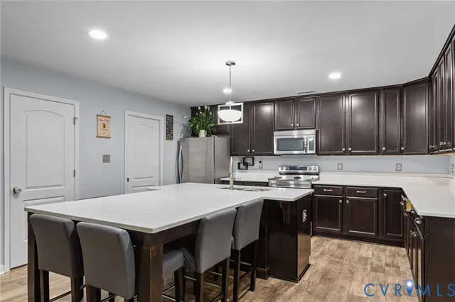 a kitchen with cabinets a sink and chairs