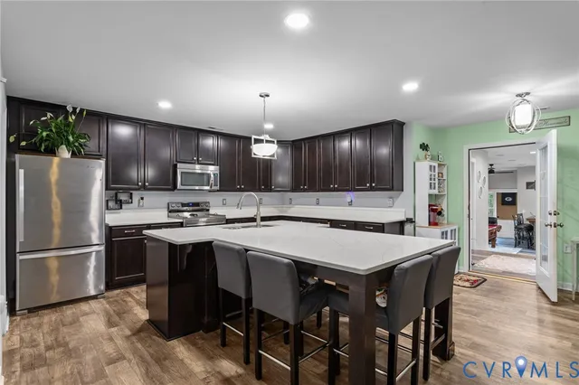 a kitchen with stainless steel appliances granite countertop a center island and a refrigerator