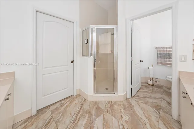 a view of a bathroom with a sink and a mirror