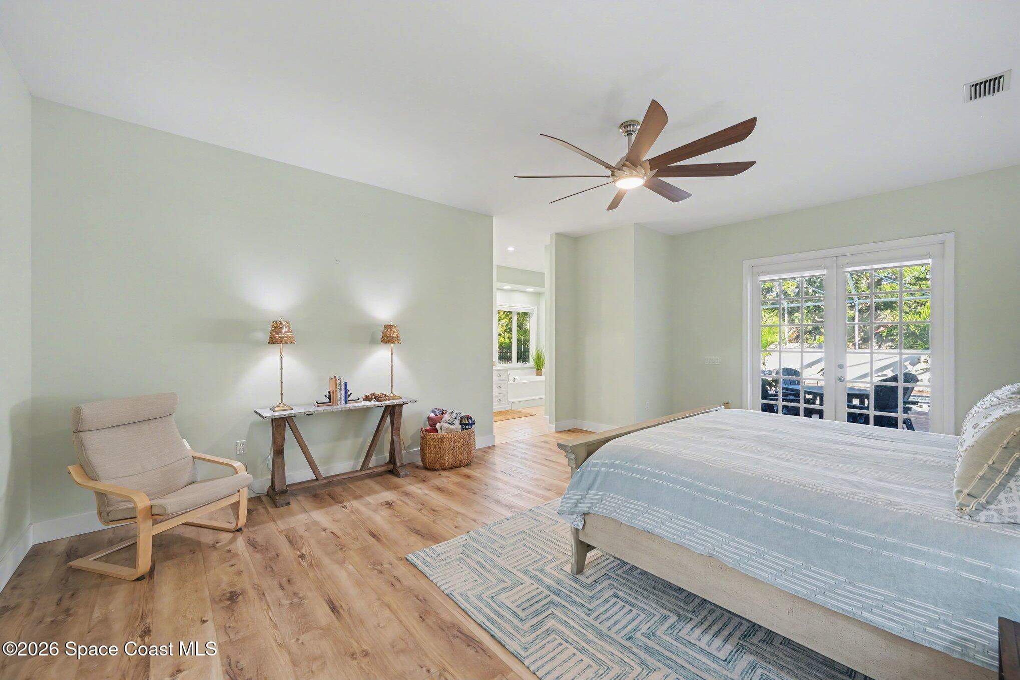 140 Utopia Circle Merritt Island, FL 32952 - Photo 17 of 55 a bedroom with a bed a table and chair