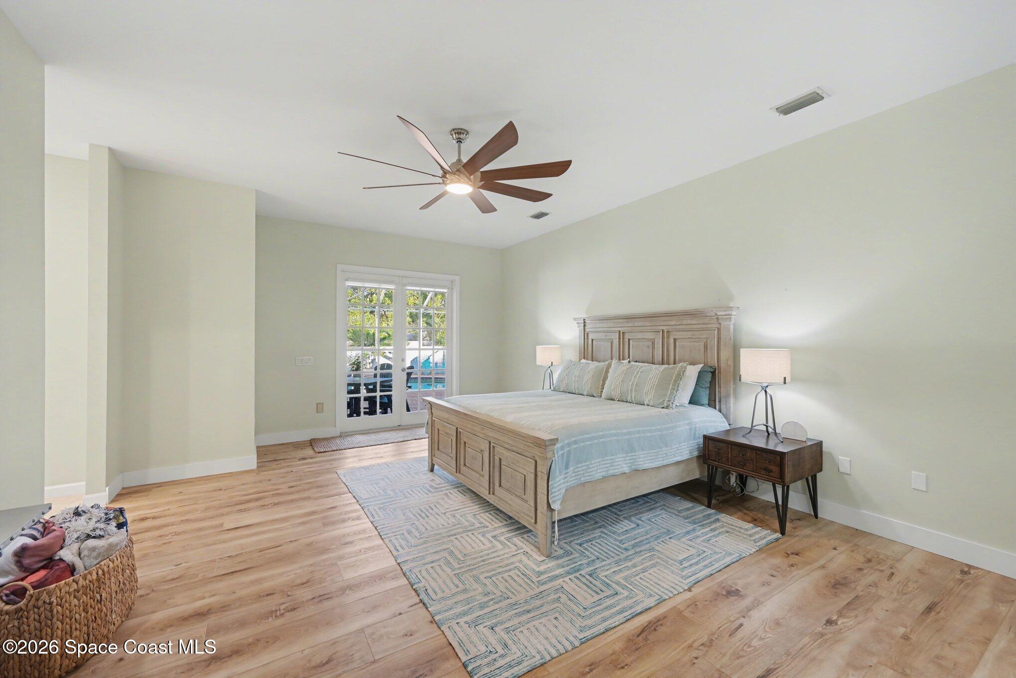 140 Utopia Circle Merritt Island, FL 32952 - Photo 16 of 54 a spacious bedroom with a bed and a window