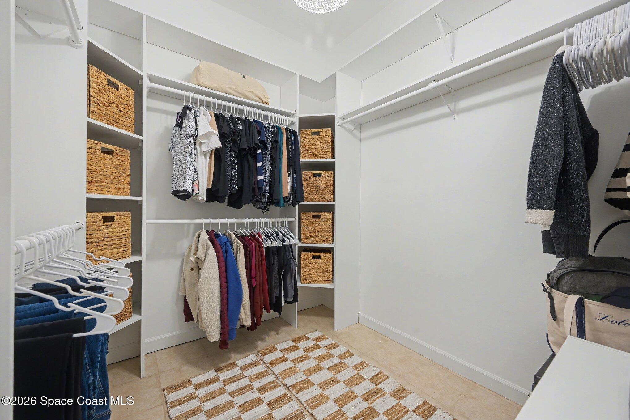 140 Utopia Circle Merritt Island, FL 32952 - Photo 21 of 55 a view of walk in closet with clothes and shoes