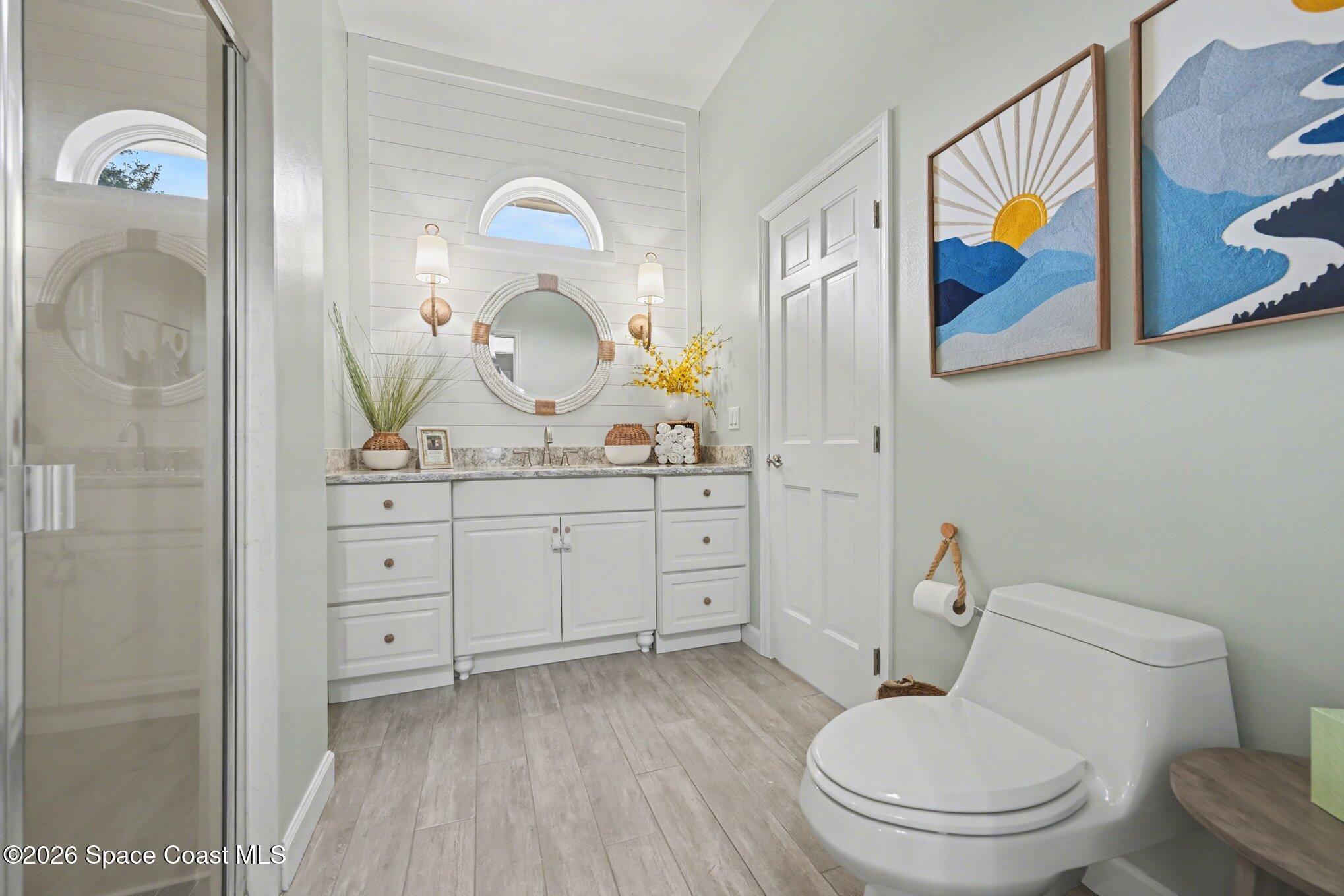 140 Utopia Circle Merritt Island, FL 32952 - Photo 26 of 55 a bathroom with a toilet a sink and mirror