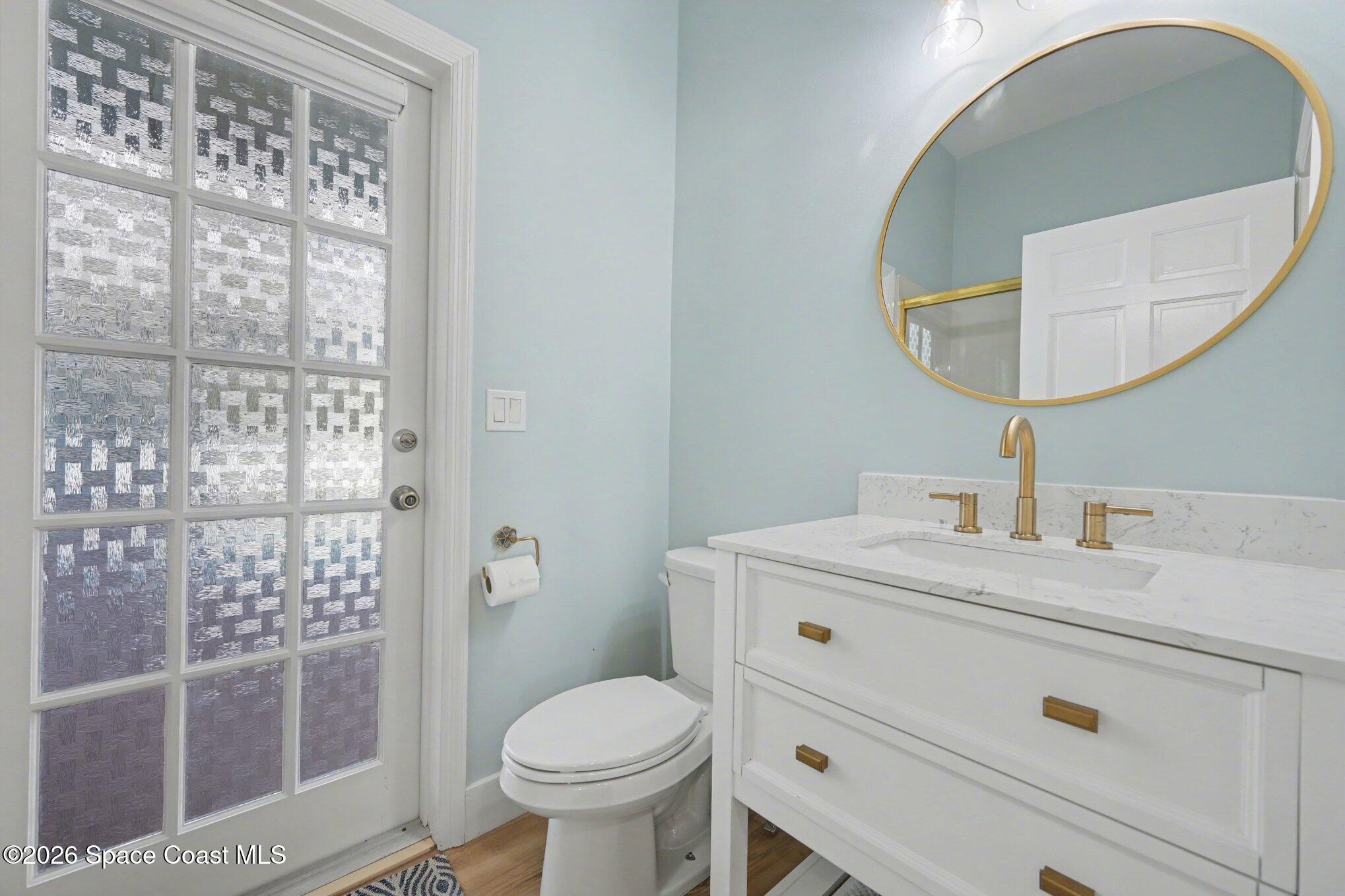 140 Utopia Circle Merritt Island, FL 32952 - Photo 31 of 55 a bathroom with a sink a toilet and a mirror