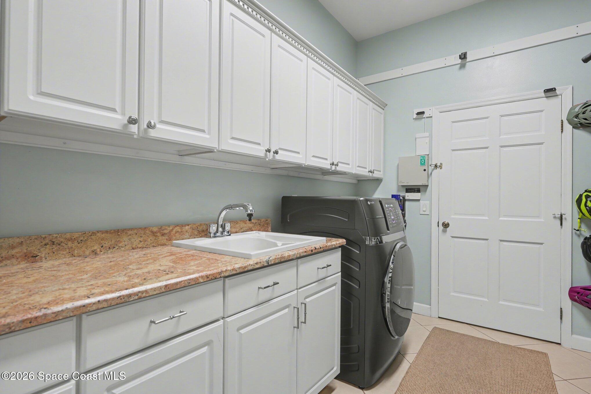 140 Utopia Circle Merritt Island, FL 32952 - Photo 32 of 55 a kitchen with a sink and cabinets