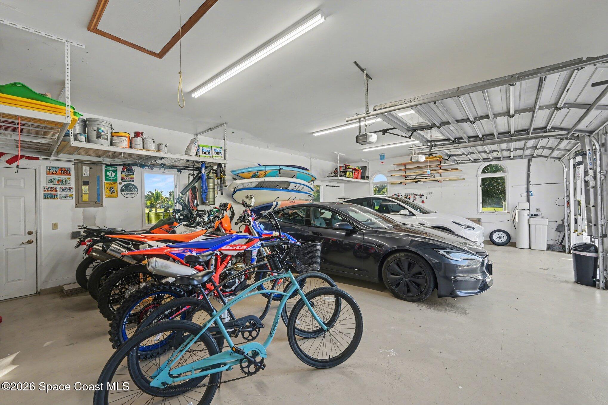 140 Utopia Circle Merritt Island, FL 32952 - Photo 33 of 55 a car and bike parked in a garage
