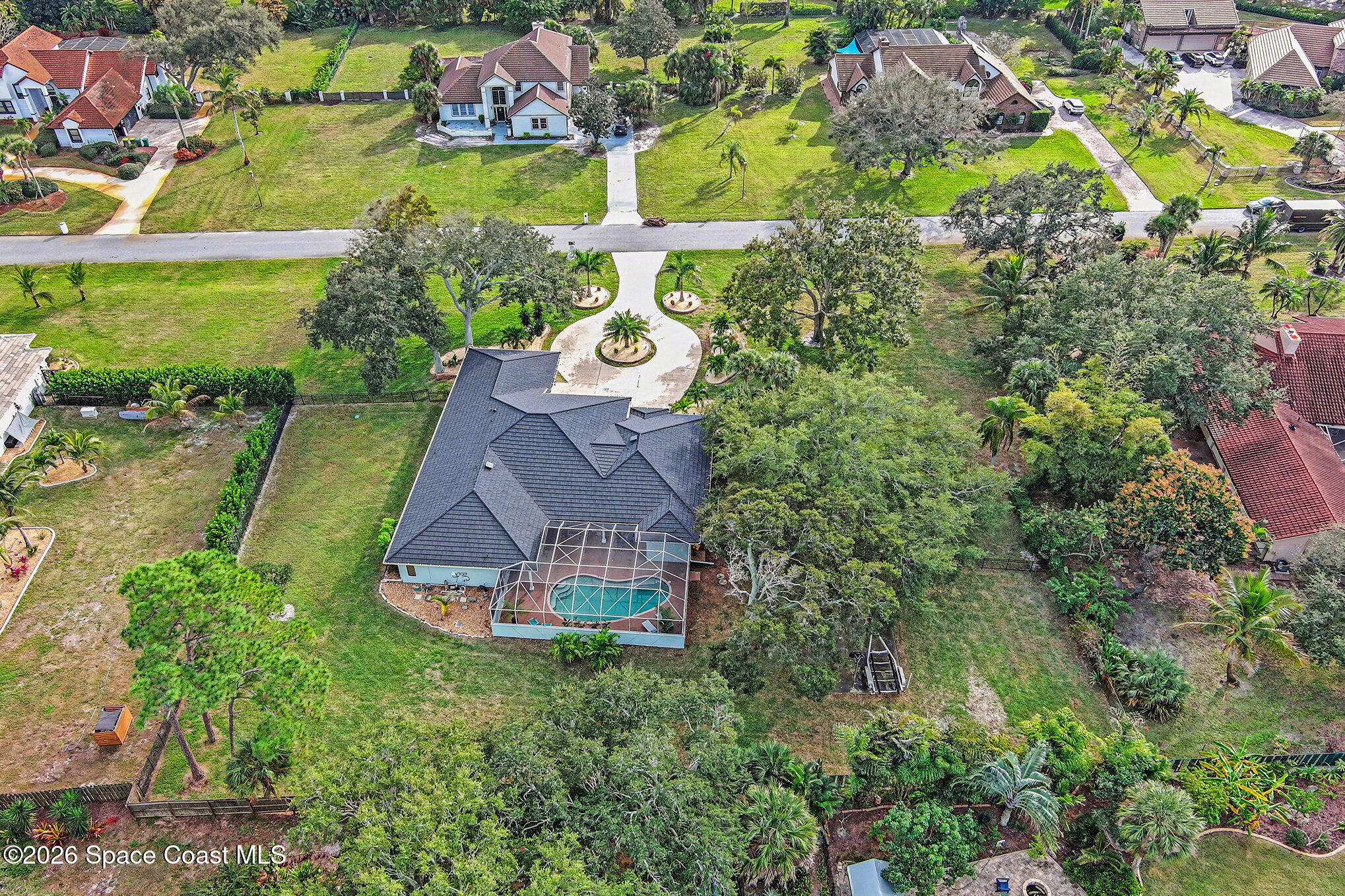 140 Utopia Circle Merritt Island, FL 32952 - Photo 36 of 55 an aerial view of a house with a garden and swimming pool