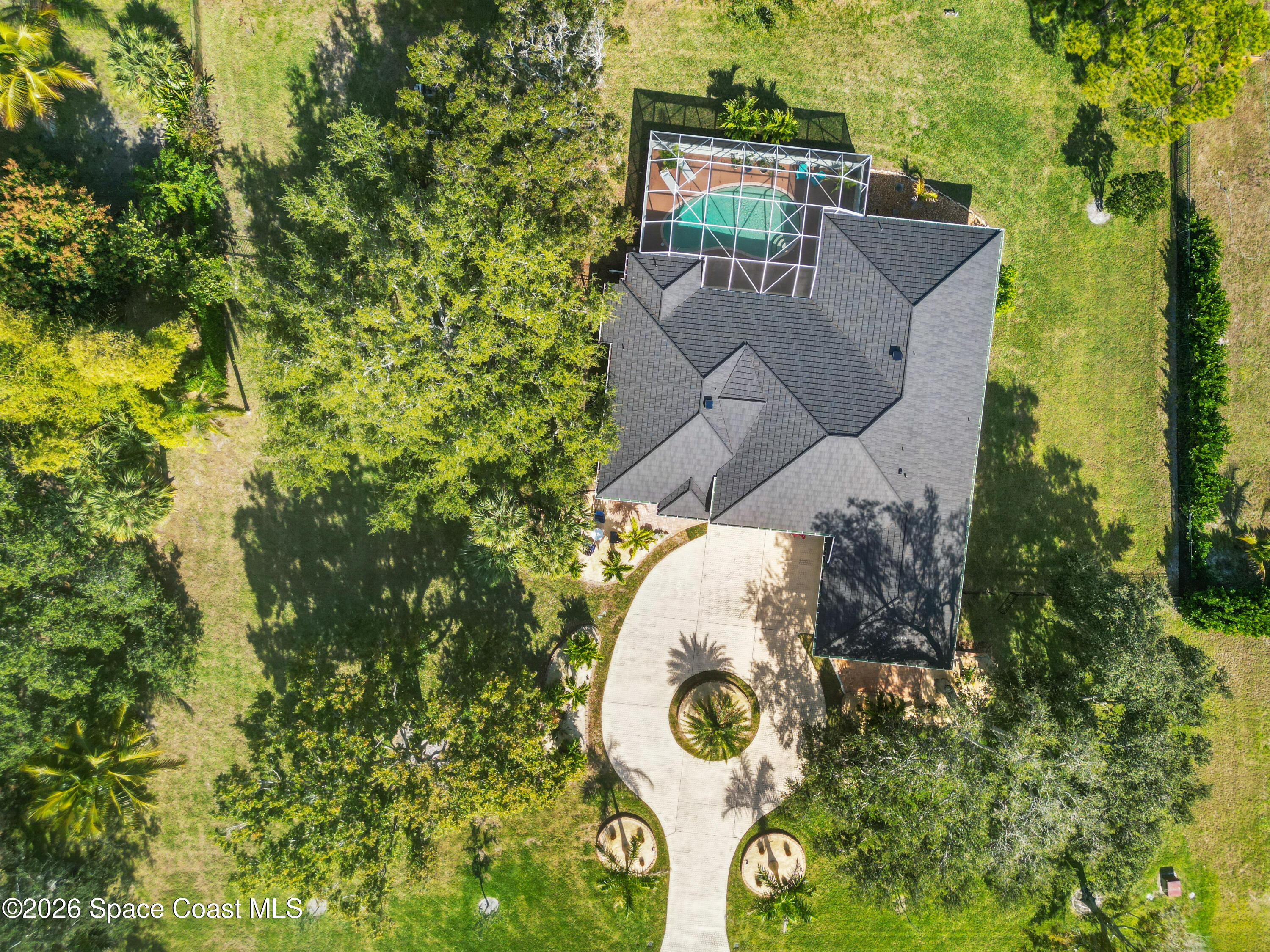 140 Utopia Circle Merritt Island, FL 32952 - Photo 44 of 55 an aerial view of a house with a yard and trees all around