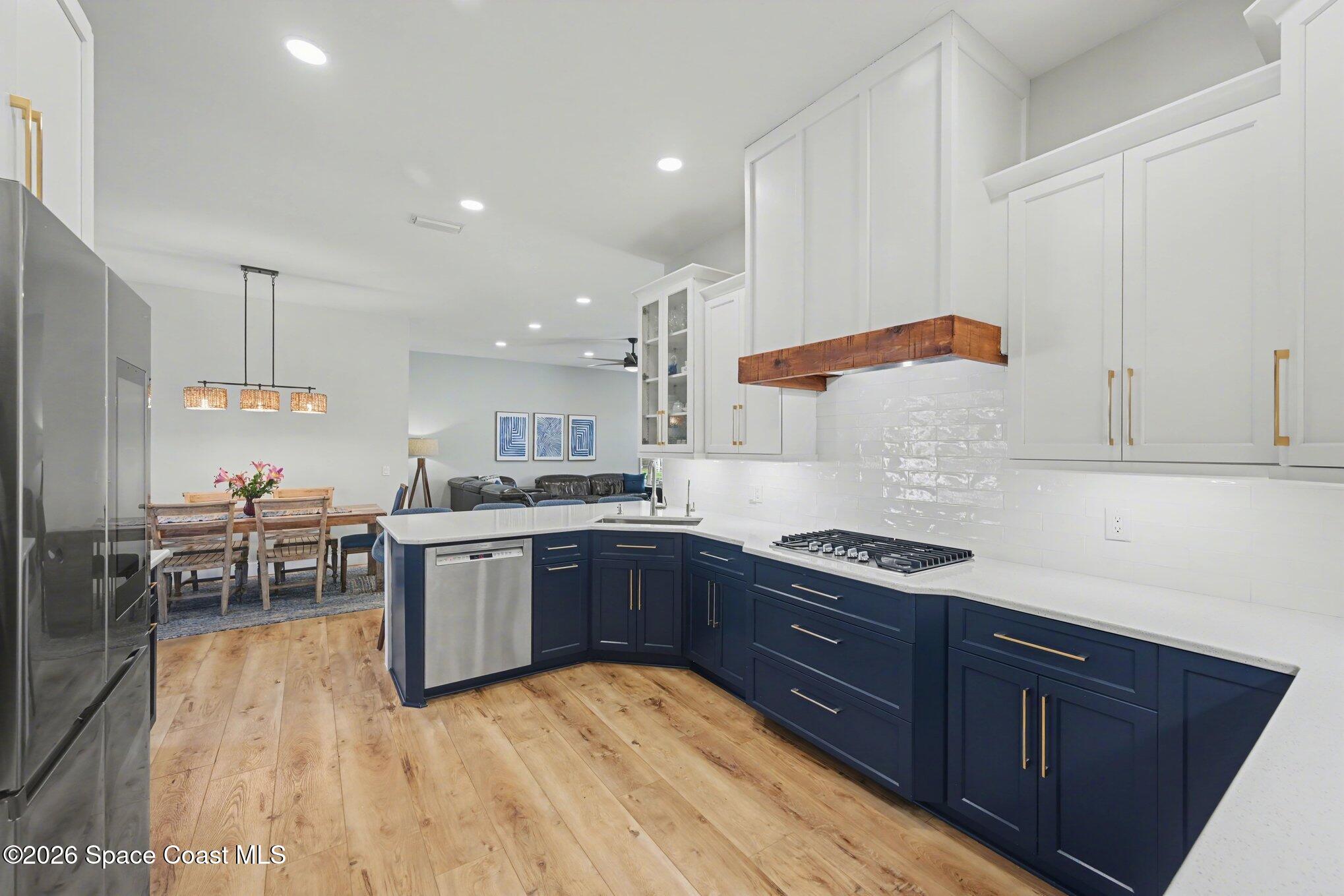 140 Utopia Circle Merritt Island, FL 32952 - Photo 10 of 55 a kitchen with stainless steel appliances granite countertop a sink and wooden cabinets