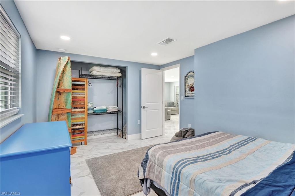 1009 Ridge Street Naples, FL 34103 - Photo 22 of 30 Bedroom featuring light marble finish floors and recessed lighting