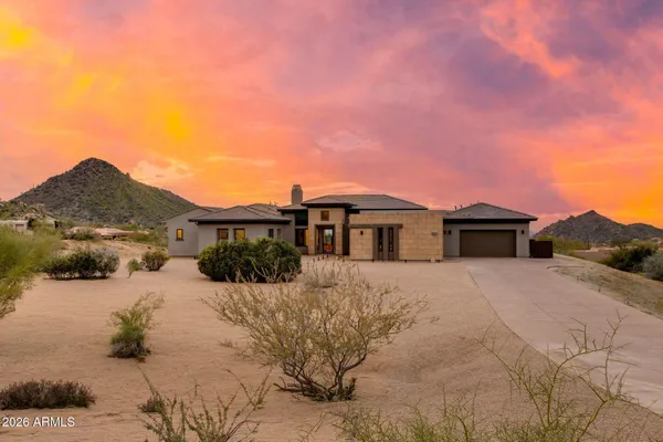 a view of a house with a yard covered in snow