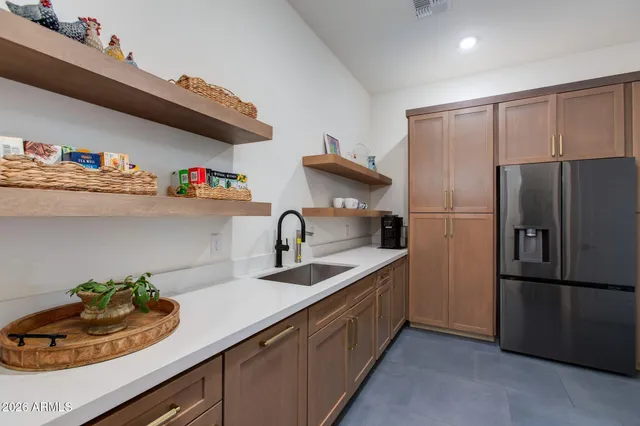 a bedroom with a bed and a dresser next to a window