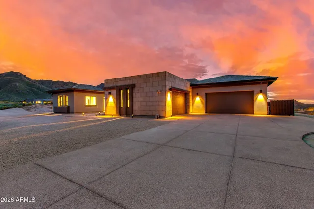 a view of a dining room with furniture a fireplace and chandelier