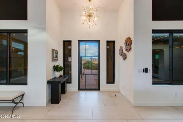 a view of a dining room with furniture a fireplace and chandelier