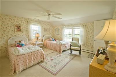 61 Shore Road Chatham, MA 02633 - Photo 16 of 28 a bedroom with furniture and a wooden floor