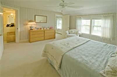 61 Shore Road Chatham, MA 02633 - Photo 17 of 28 a spacious bedroom with a bed and a dresser