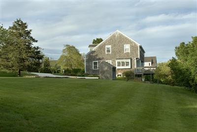 61 Shore Road Chatham, MA 02633 - Photo 3 of 28 a front view of a house with a yard and trees