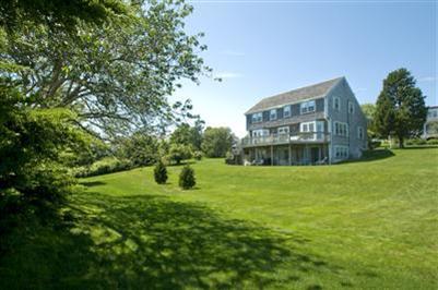 61 Shore Road Chatham, MA 02633 - Photo 5 of 28 a view of a big house with a big yard and large trees