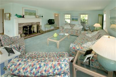 61 Shore Road Chatham, MA 02633 - Photo 10 of 28 a living room with furniture and a fireplace