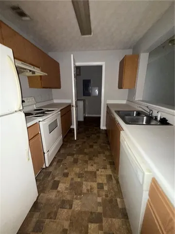 a kitchen with a stove a sink and a refrigerator