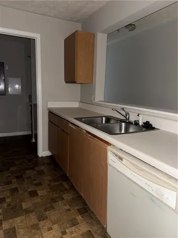 a kitchen with a stove and a white cabinet