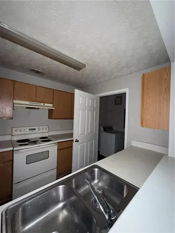 a kitchen with a stove and a refrigerator