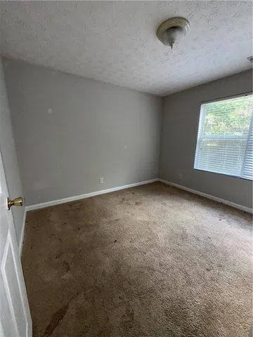 an empty room with a empty space and windows