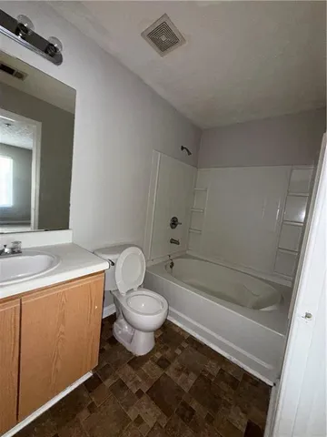 a bathroom with a sink toilet a mirror and shower