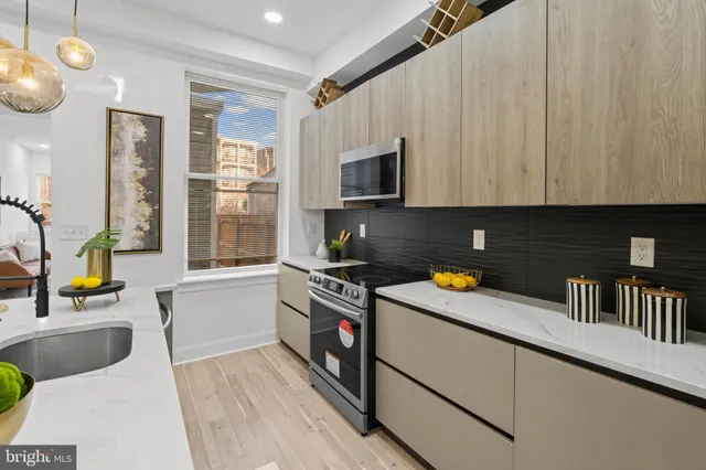a view of a livingroom with furniture staircase and a potted plant