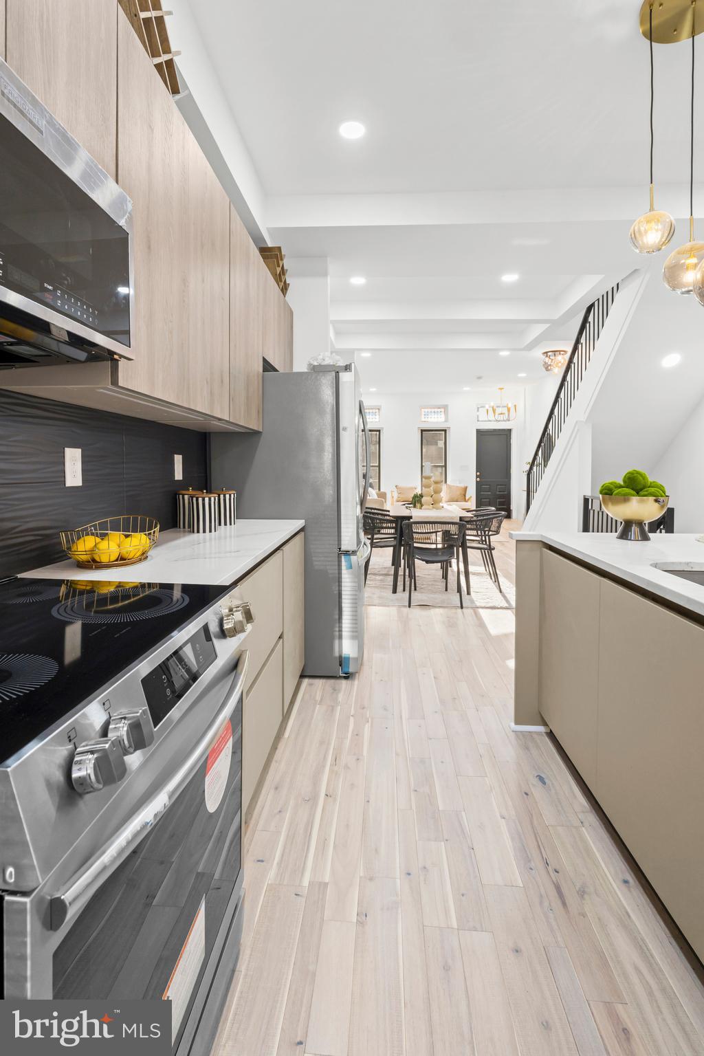 2321 Madison Avenue Baltimore, MD 21217 - Photo 12 of 55 a kitchen with stainless steel appliances granite countertop a stove and a wooden floors