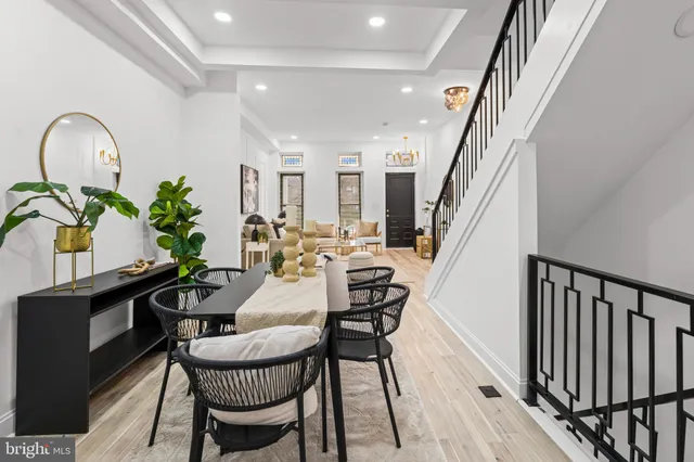 a view of a dining room with furniture and a potted plant