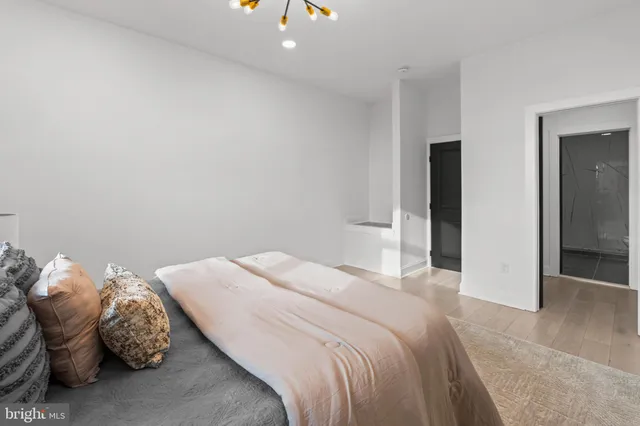 a bedroom with a bed and a painting on the wall