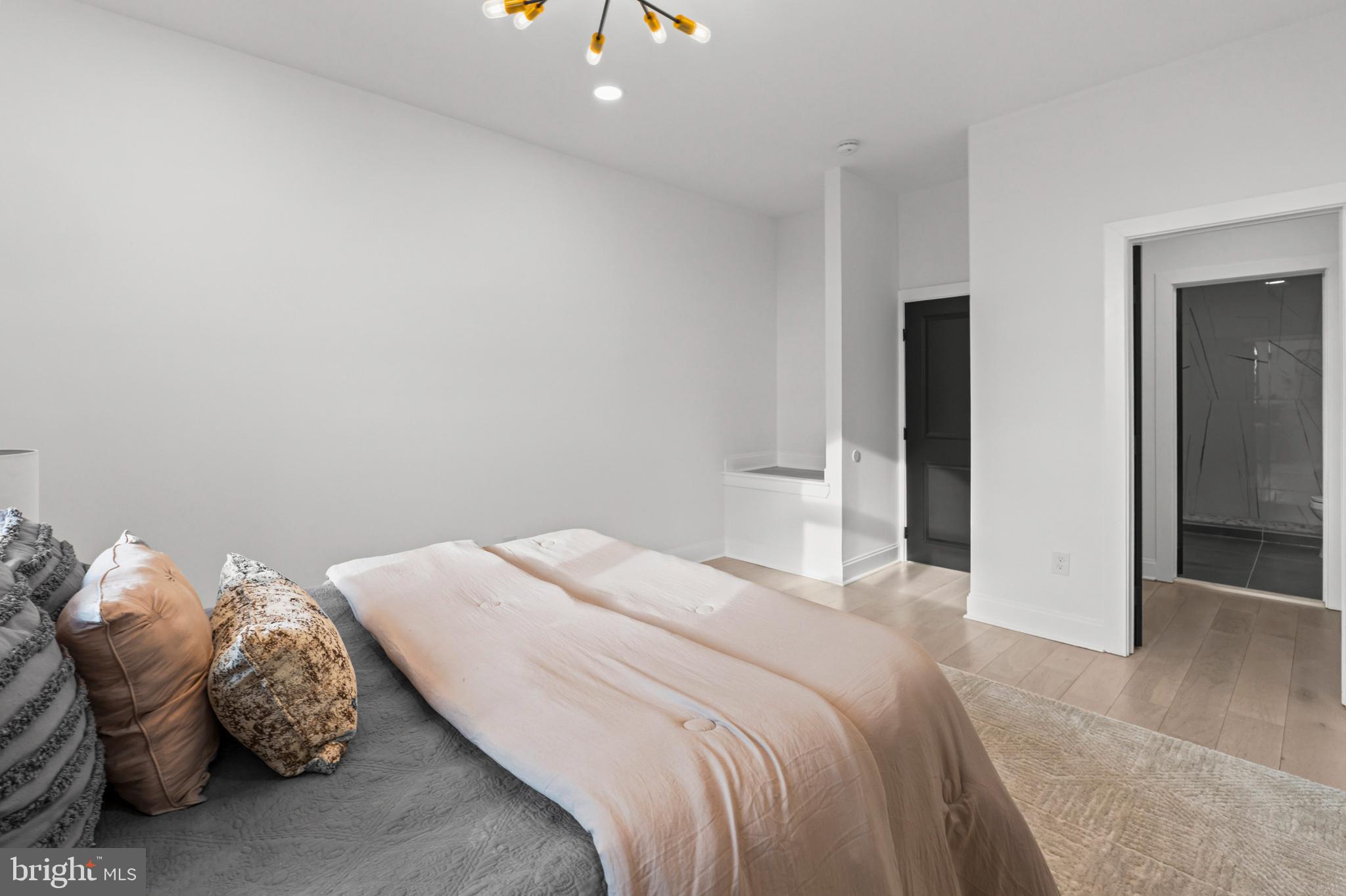 2321 Madison Avenue Baltimore, MD 21217 - Photo 21 of 55 a bedroom with a bed and a chandelier