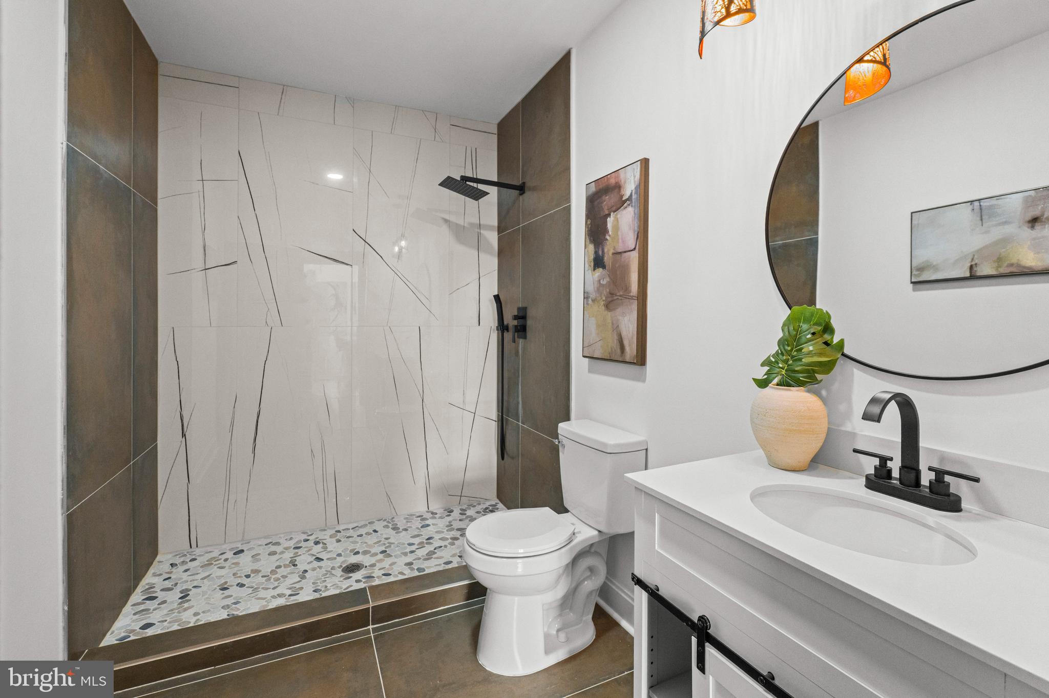 2321 Madison Avenue Baltimore, MD 21217 - Photo 22 of 55 a bathroom with a sink a toilet and a mirror