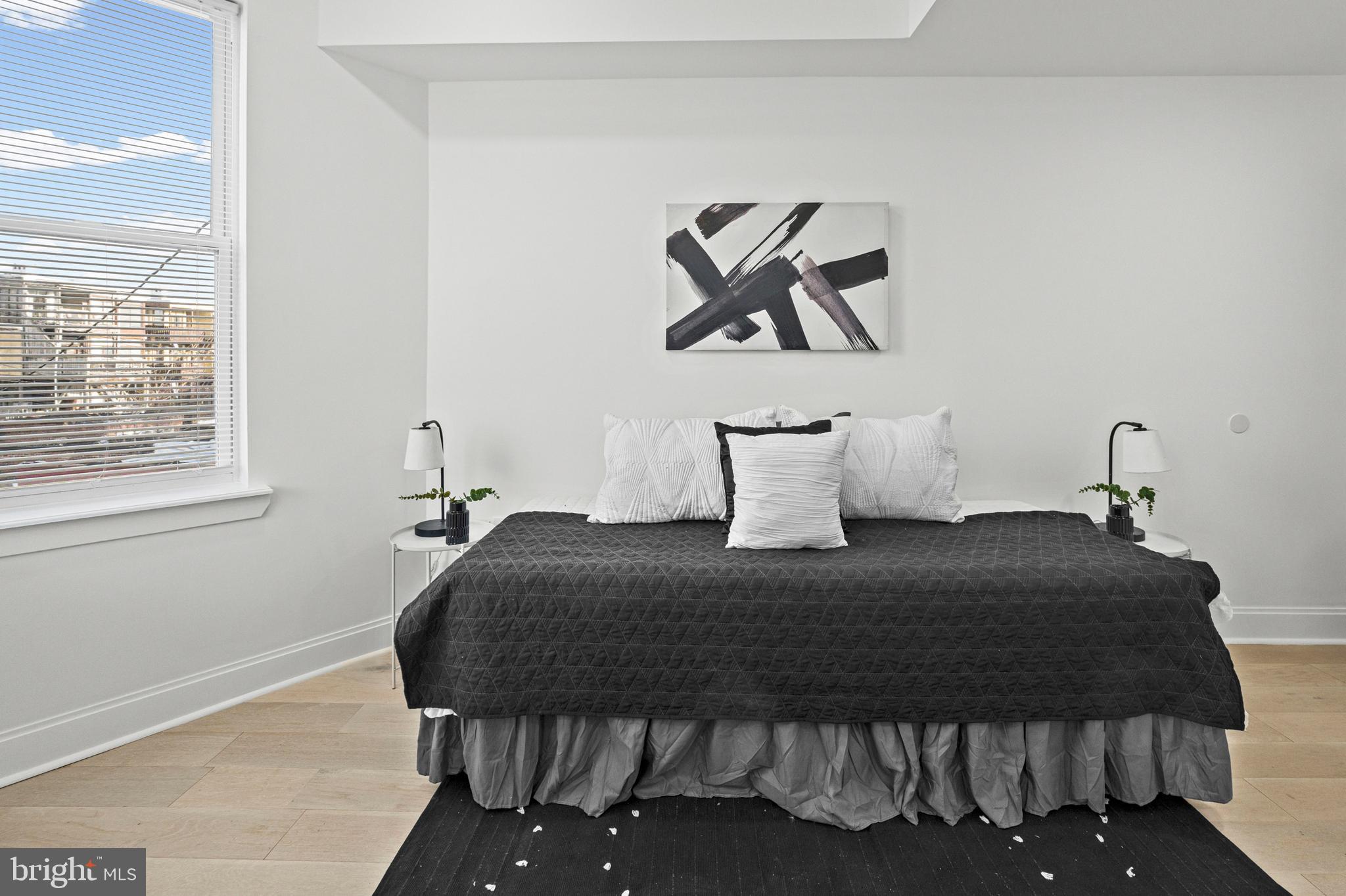 2321 Madison Avenue Baltimore, MD 21217 - Photo 27 of 55 a bedroom with a bed and painting on the wall