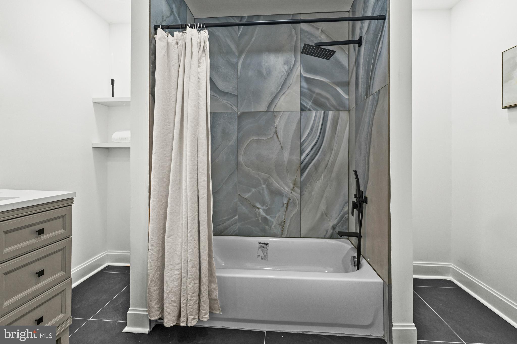 2321 Madison Avenue Baltimore, MD 21217 - Photo 29 of 55 a bathroom with a bathtub and a shower