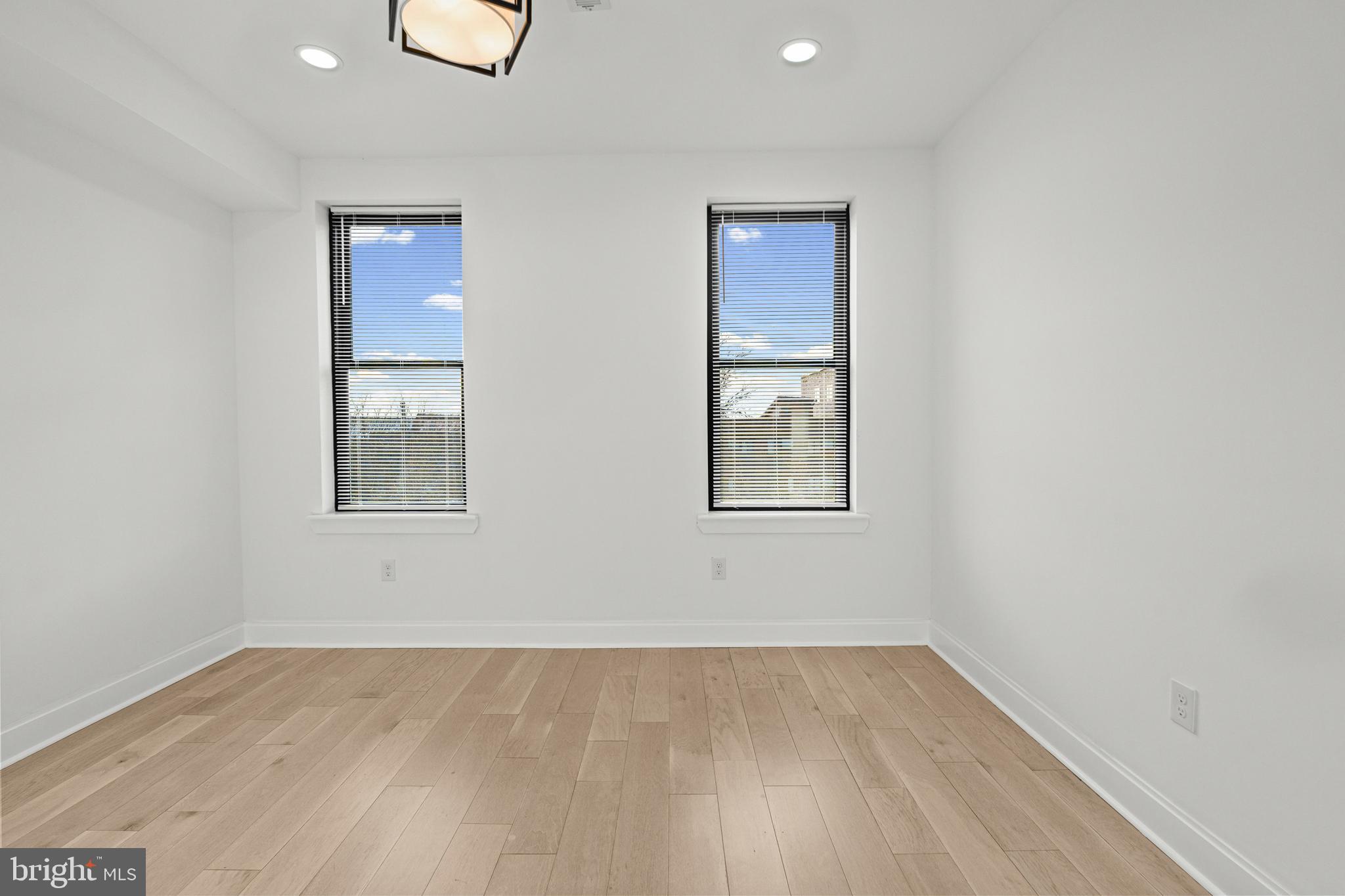 2321 Madison Avenue Baltimore, MD 21217 - Photo 31 of 55 an empty room with wooden floor and windows