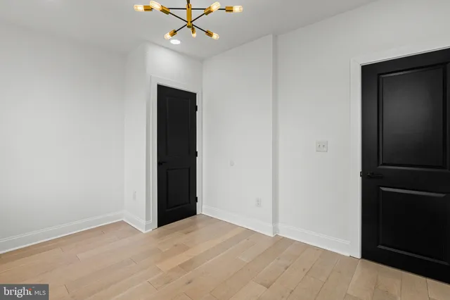 a view of a hallway with wooden floor and entryway