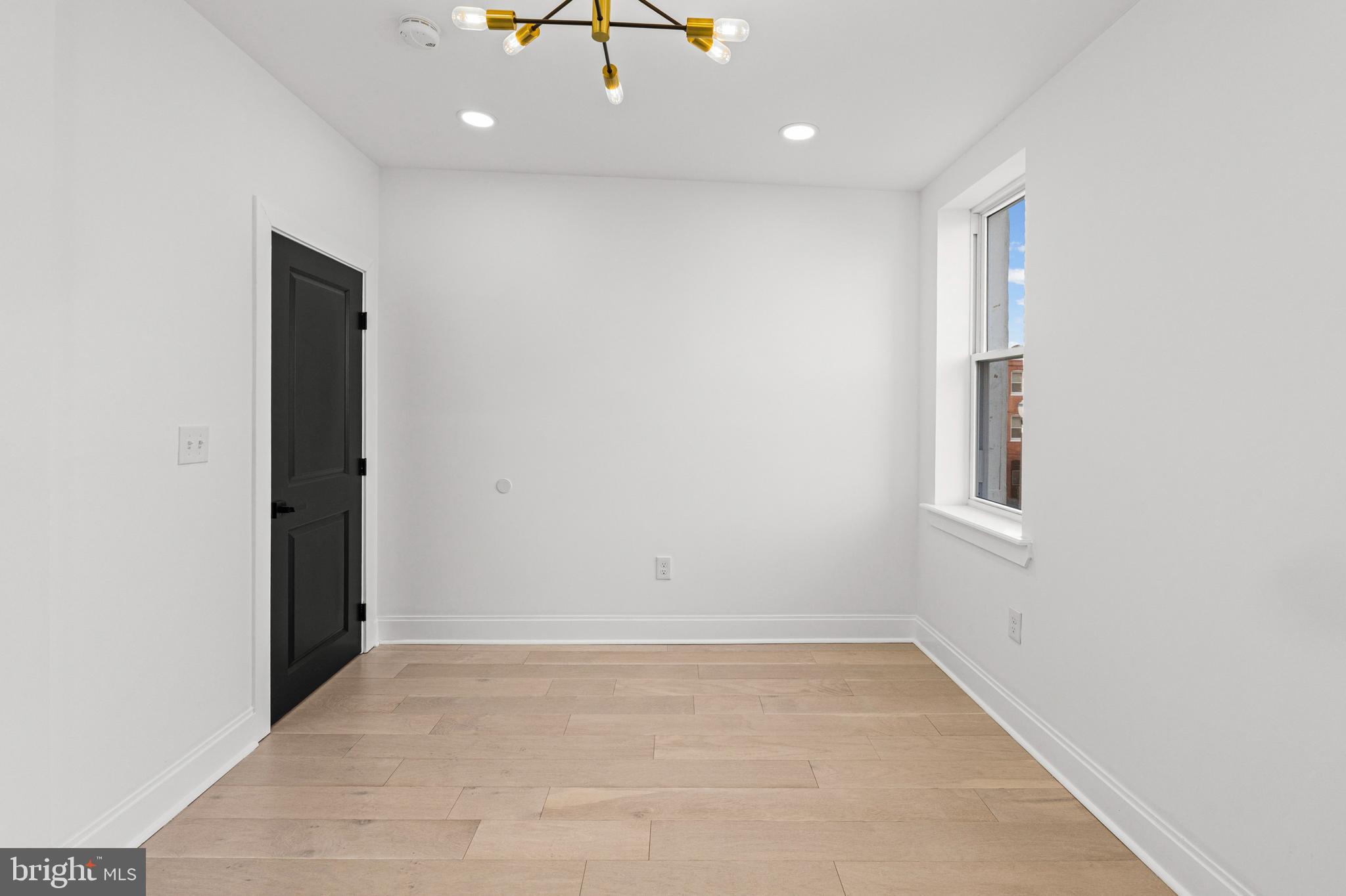2321 Madison Avenue Baltimore, MD 21217 - Photo 37 of 55 an empty room with cabinet and chandelier fan