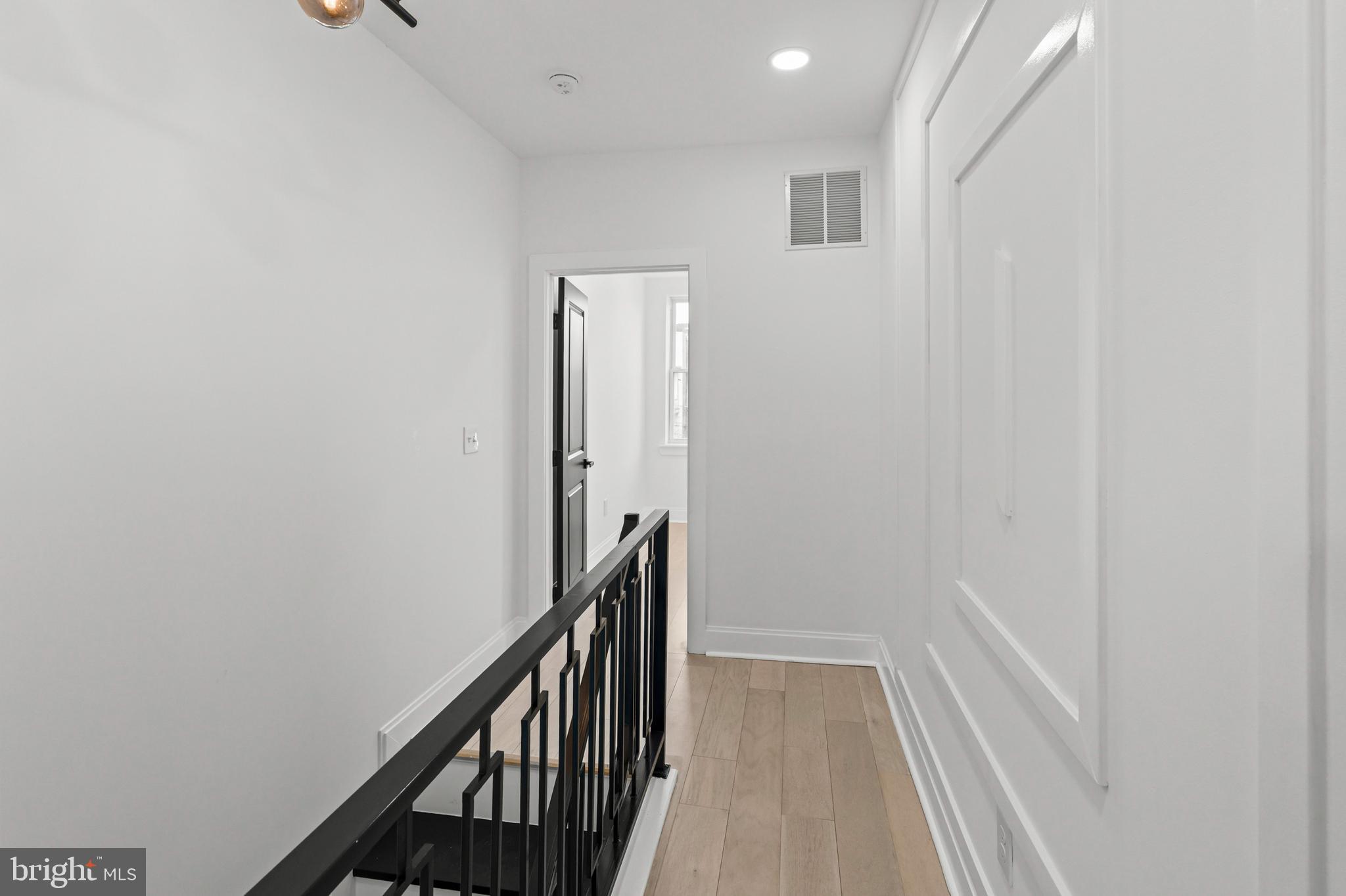 2321 Madison Avenue Baltimore, MD 21217 - Photo 38 of 55 a view of a hallway with wooden floor and entryway