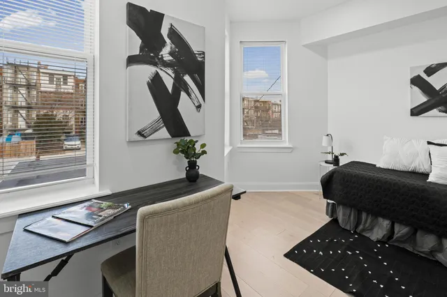 a bathroom with a toilet a sink and a mirror