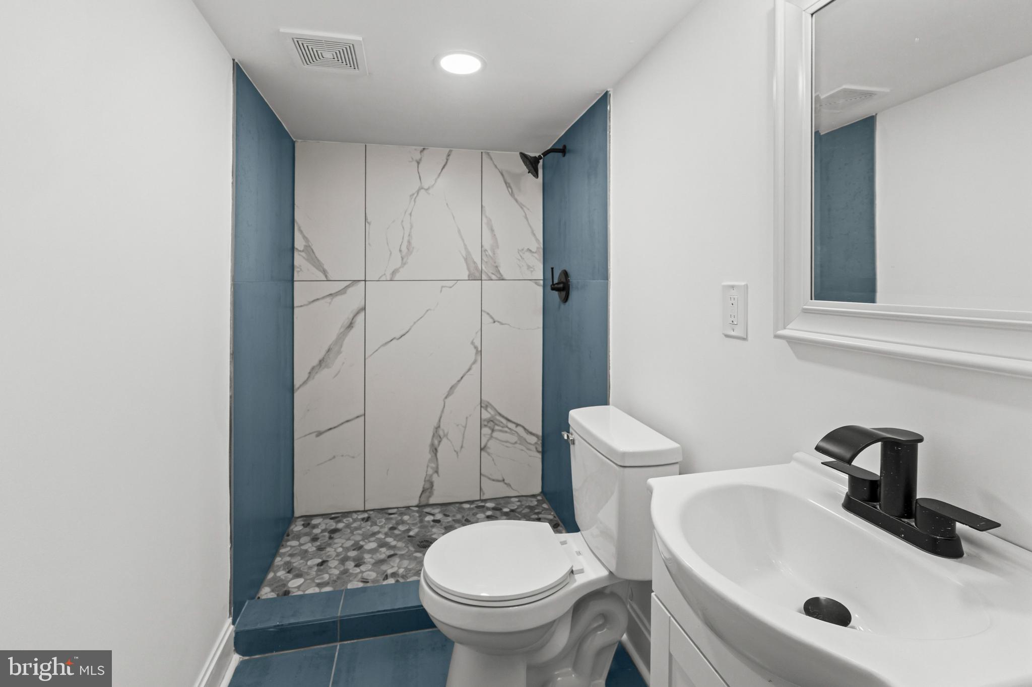 2321 Madison Avenue Baltimore, MD 21217 - Photo 40 of 55 a bathroom with a sink a toilet and shower