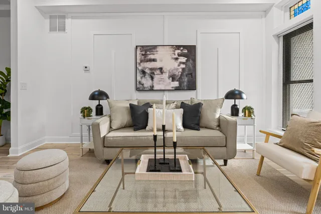 a living room with furniture and a potted plant
