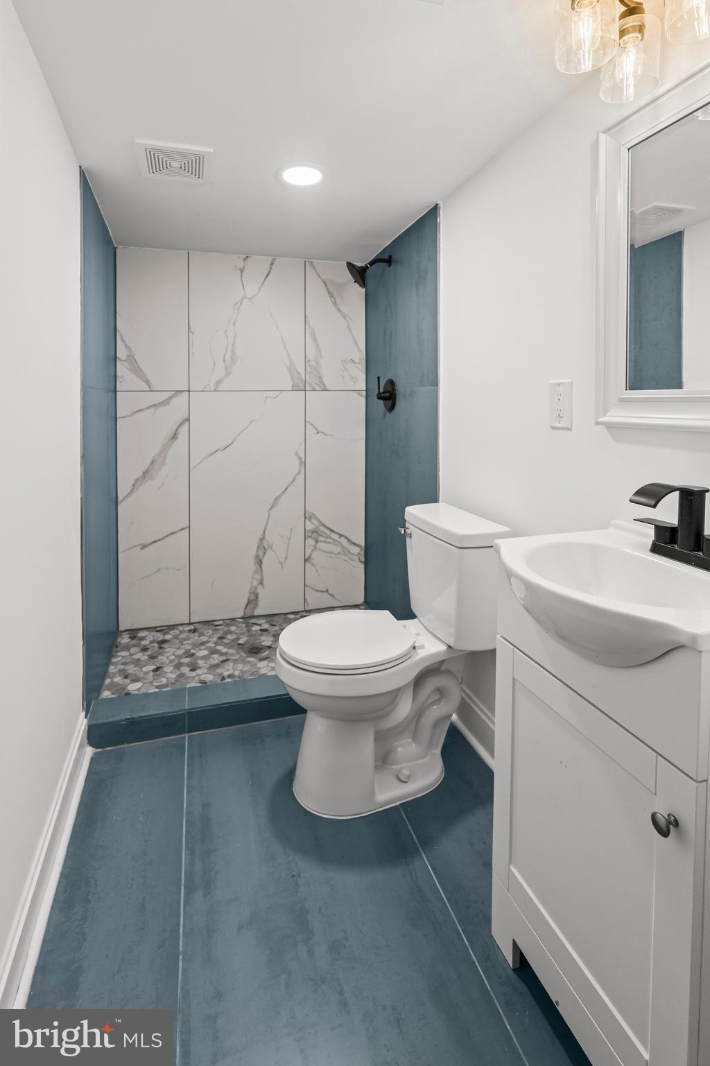 2321 Madison Avenue Baltimore, MD 21217 - Photo 41 of 55 a bathroom with a toilet a sink and a mirror