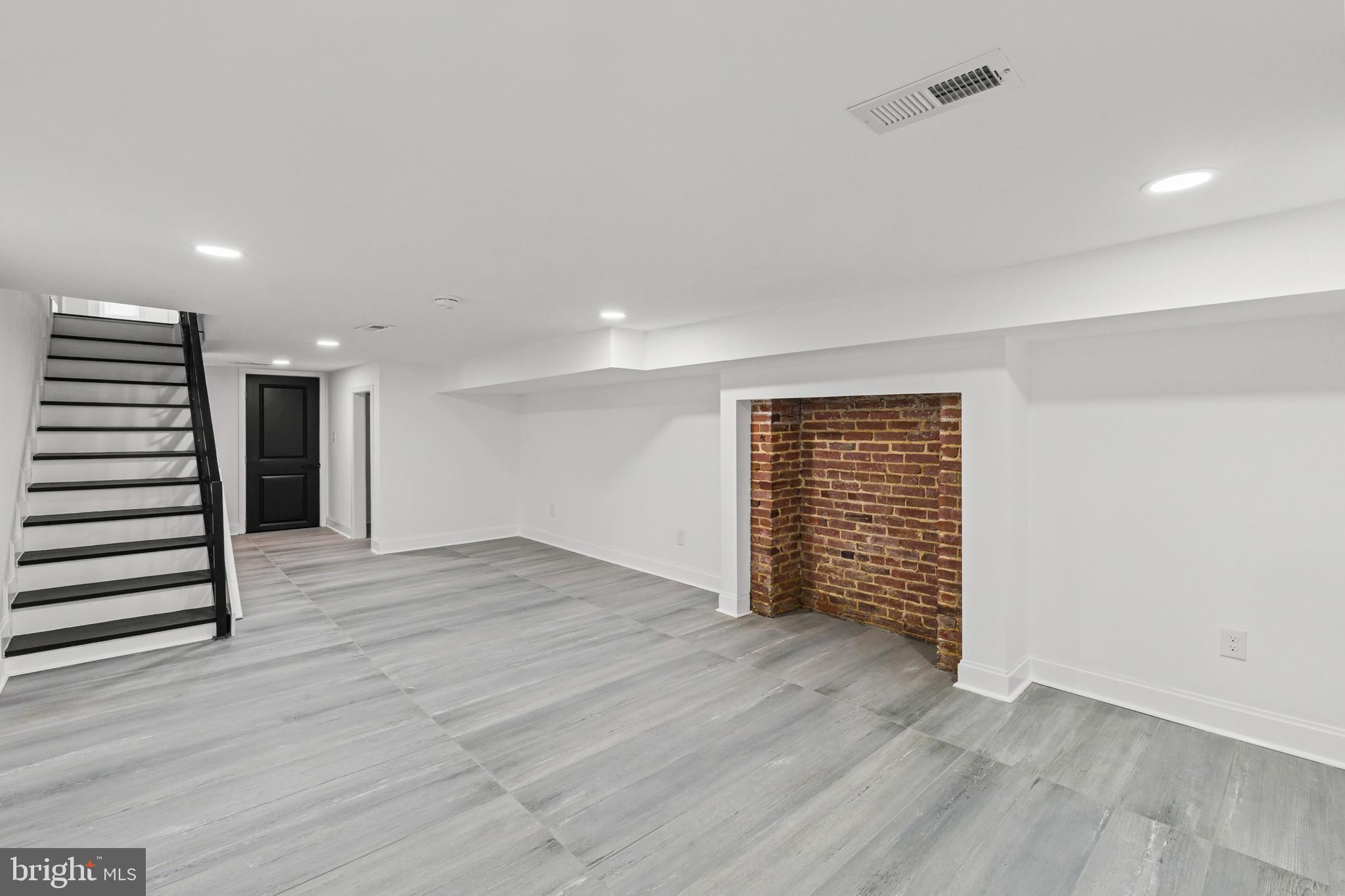 2321 Madison Avenue Baltimore, MD 21217 - Photo 45 of 55 an empty room with wooden floor and windows