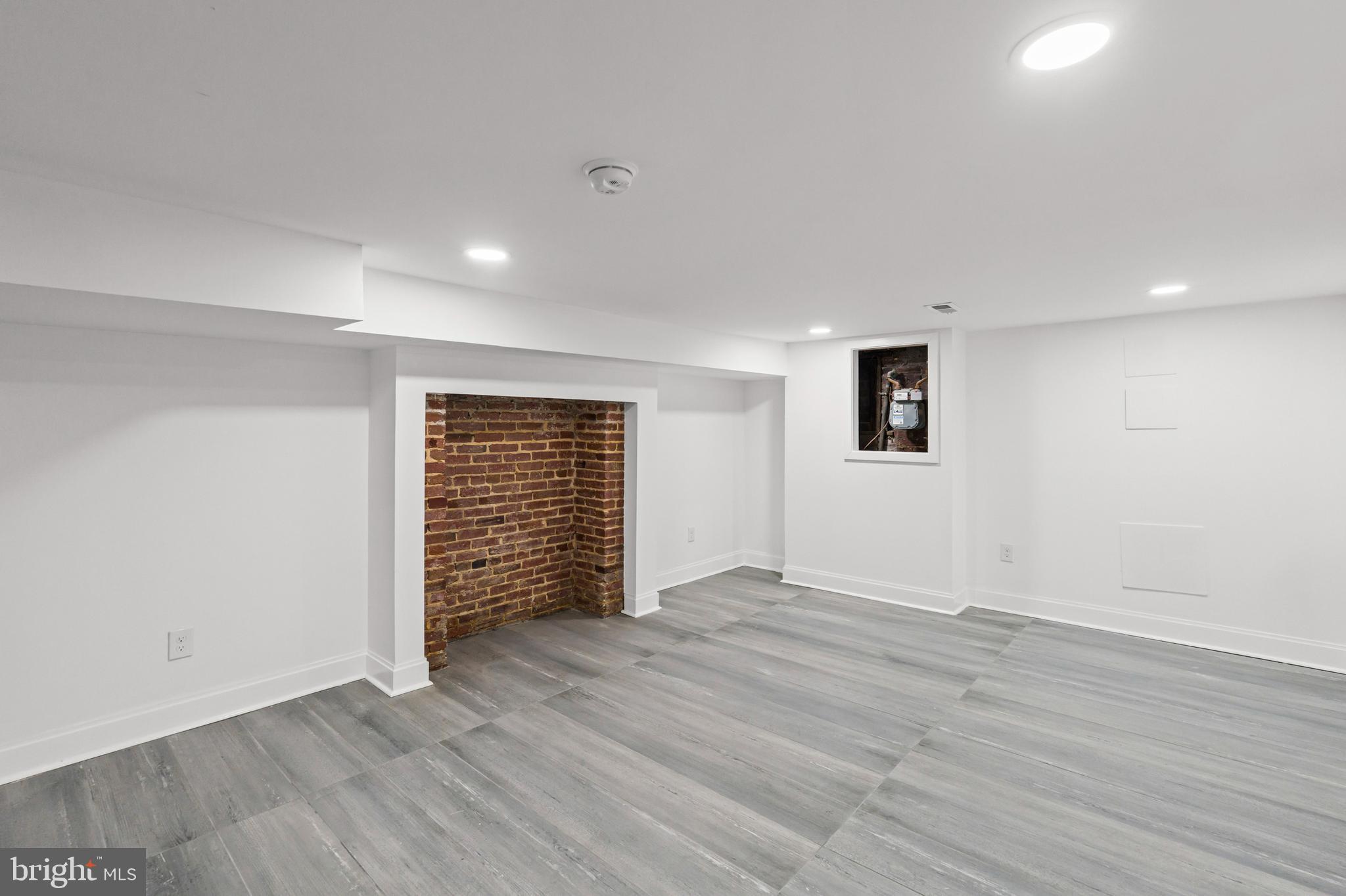 2321 Madison Avenue Baltimore, MD 21217 - Photo 46 of 55 a view of an empty room with wooden floor and a window