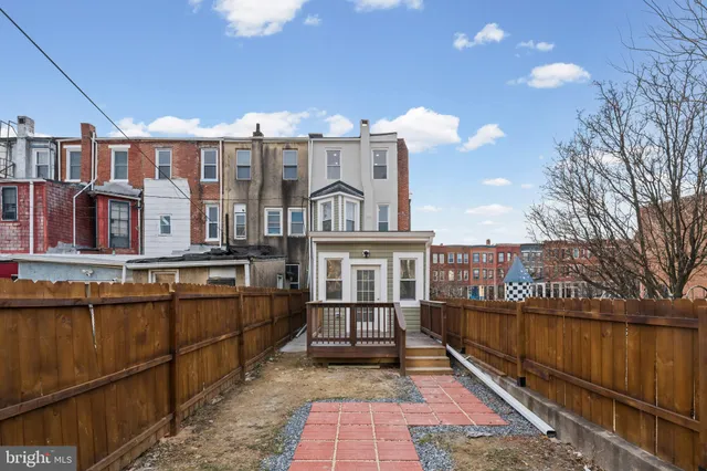 a front view of a residential apartment building with a yard