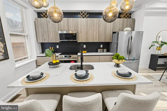 a kitchen with a table and chairs