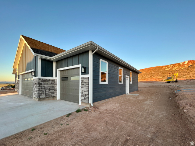 6 South 450th West Gunnison, UT 84634 - Photo 4 of 45 Contemporary exterior showcasing dark gray horizontal siding, stone veneer accents, and white trim